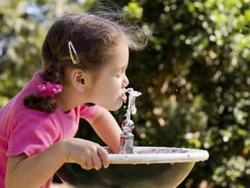 Girl Drinking water from tap